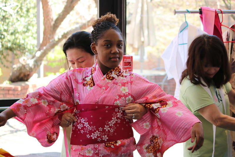 Cherry Blossom Festival at Spelman College - Female being fitted into a Japanese kimono