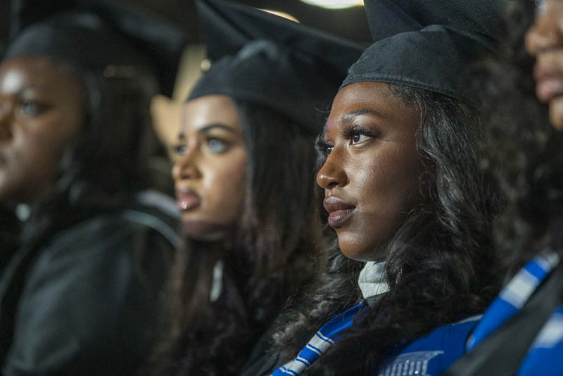 Spelman College Commencement 2024 graduates intently listening to speech.