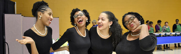Five Glee Club students laughing together